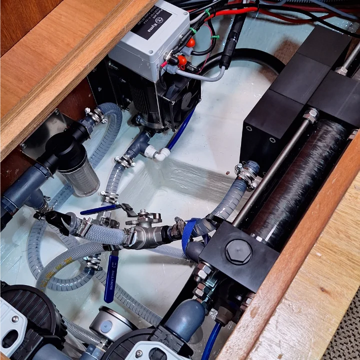 A Kyma Watermaker Kyma 30 Light installed in one of our clients boat under a seating bench.